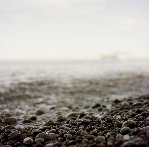 
			<br /><em>black stones
			<br />with drangey in the distance
			<br /><br />...there was so much seaglass on this beach
			<br /><br /><br /><br /><br />(at reykir farm, near the island of drangey / NW)</em>